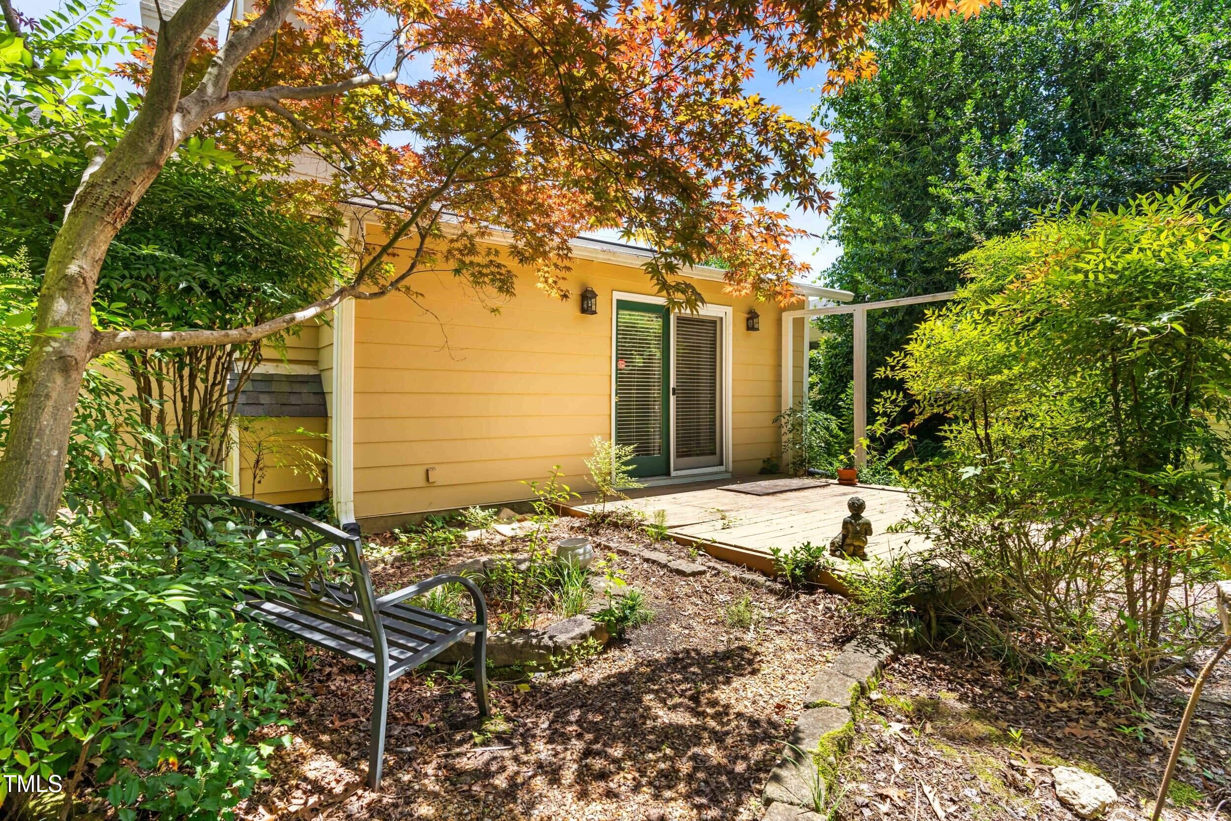 2143 Ridge Road Raleigh, NC 27607 - Photo 39 of 40 a yellow house with trees in front of it