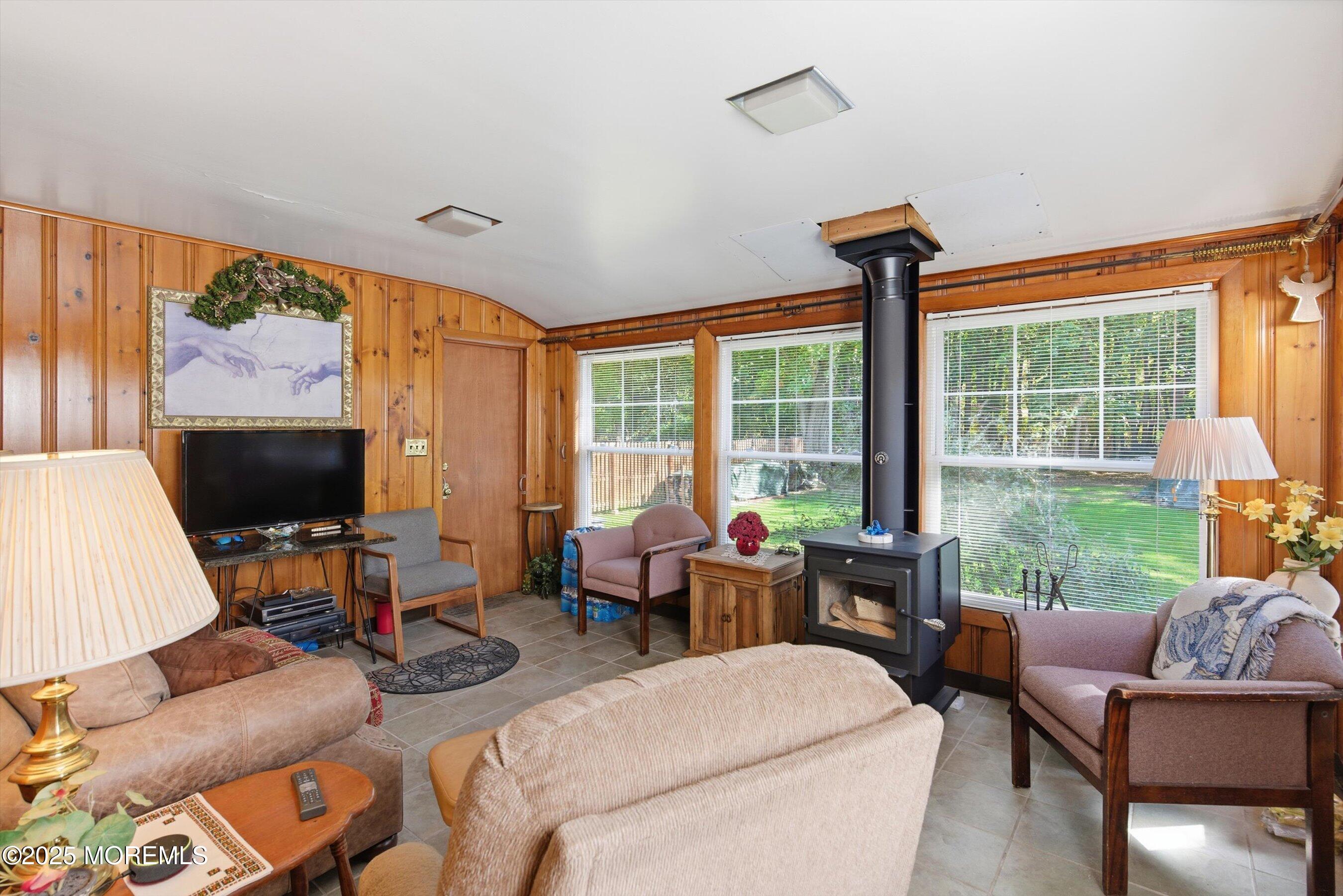 69 Harvard Road Fair Haven, NJ 07704 - Photo 11 of 30 a living room with furniture a flat screen tv and a large window