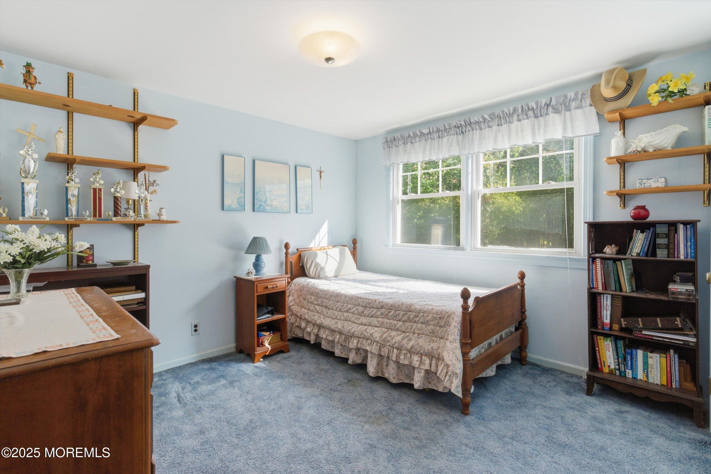 69 Harvard Road Fair Haven, NJ 07704 - Photo 17 of 30 a bedroom with a bed and a book shelf
