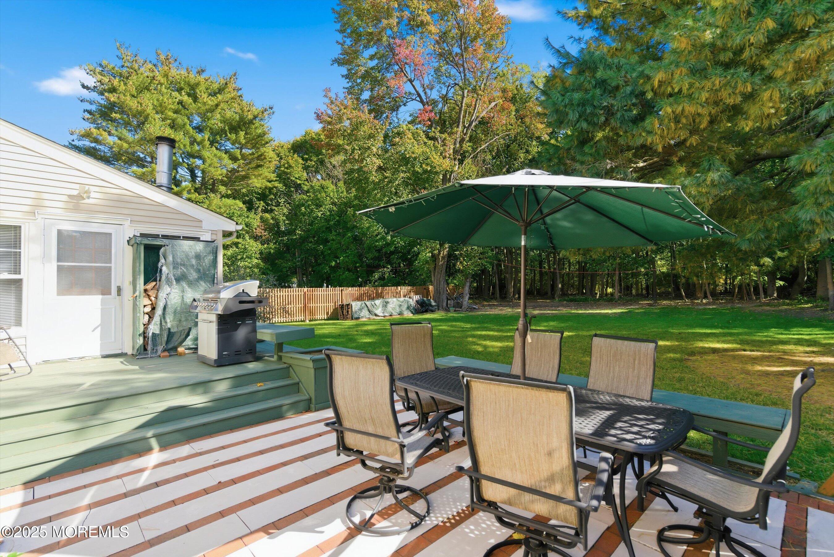 69 Harvard Road Fair Haven, NJ 07704 - Photo 24 of 30 a view of a table and chairs in patio with a yard