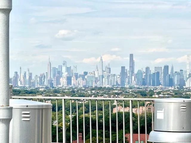 a view of a city with a tall building