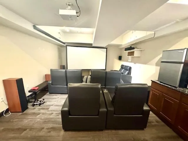 a living room with furniture a flat screen tv and a window