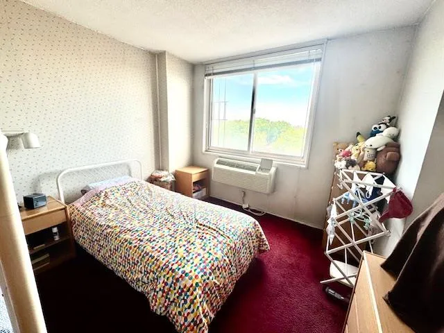 a bedroom with a bed and a wooden floor