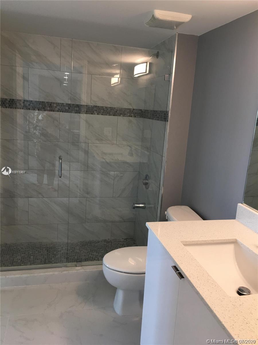 3000 Coral Way, Unit 1207 Miami, FL 33145 - Photo 4 of 8 a bathroom with a sink a toilet and shower
