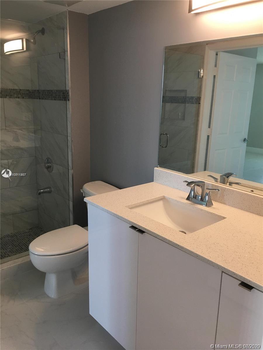 3000 Coral Way, Unit 1207 Miami, FL 33145 - Photo 8 of 8 a bathroom with a sink toilet and shower