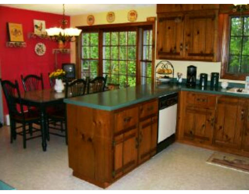 6 Owl Road Londonderry, NH 03053 - Photo 3 of 8 a kitchen with stainless steel appliances granite countertop a stove a sink and a microwave