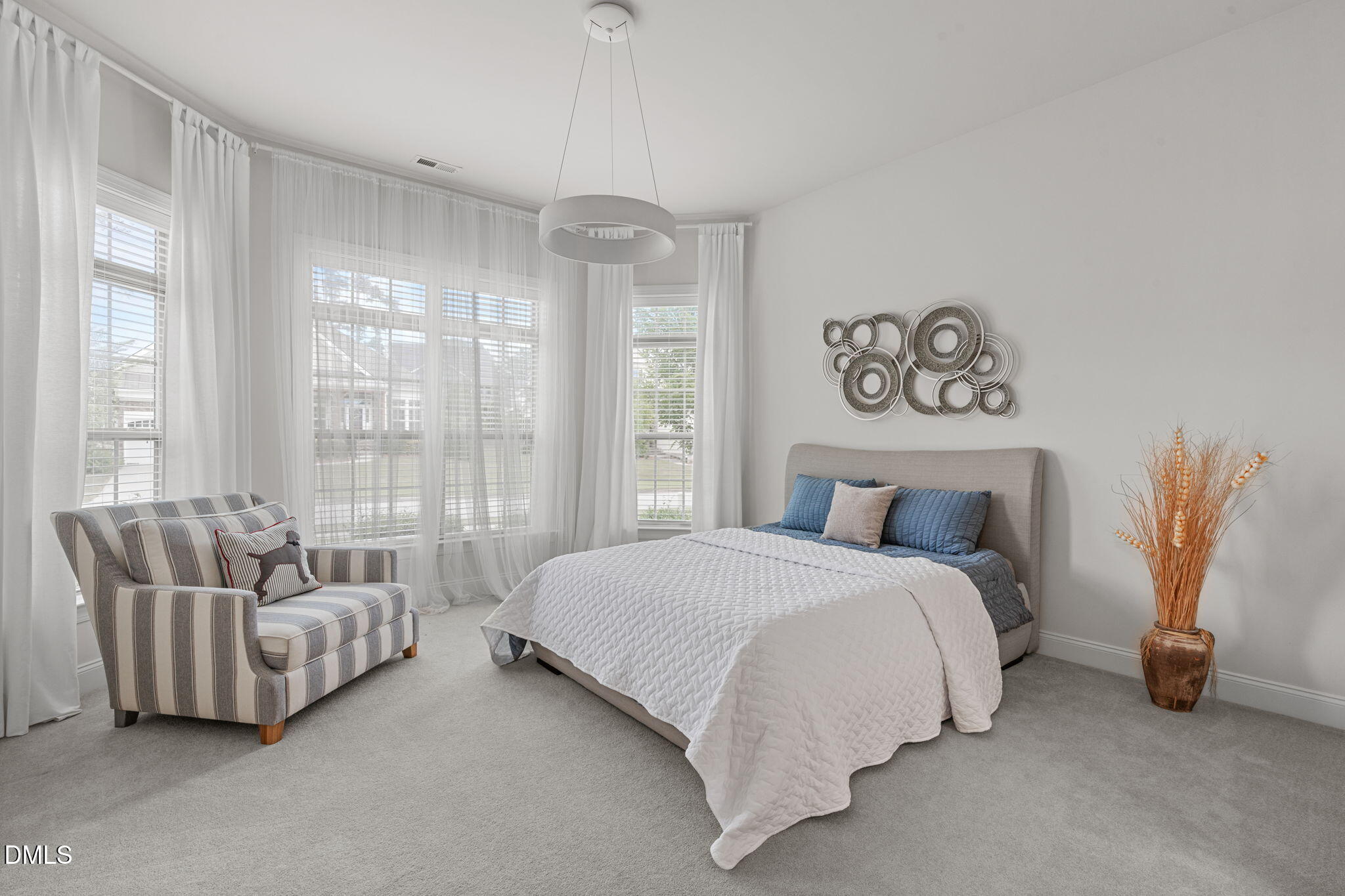 2613 Beckwith Road Apex, NC 27523 - Photo 27 of 73 a spacious bedroom with a bed and a couch