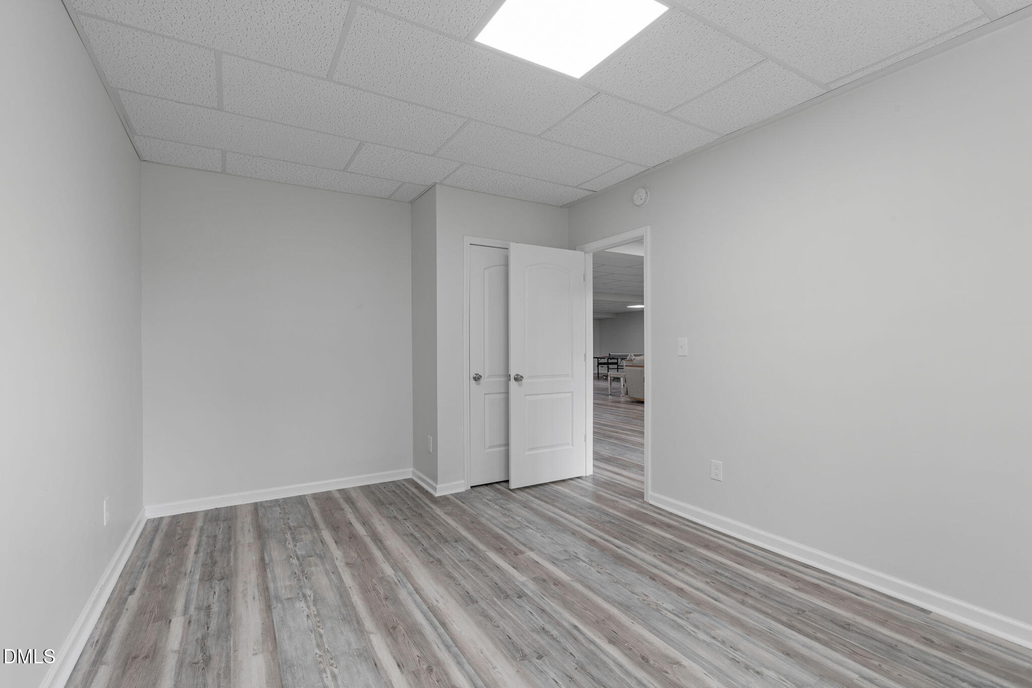 2613 Beckwith Road Apex, NC 27523 - Photo 57 of 73 a view of a room with wooden floor and white walls