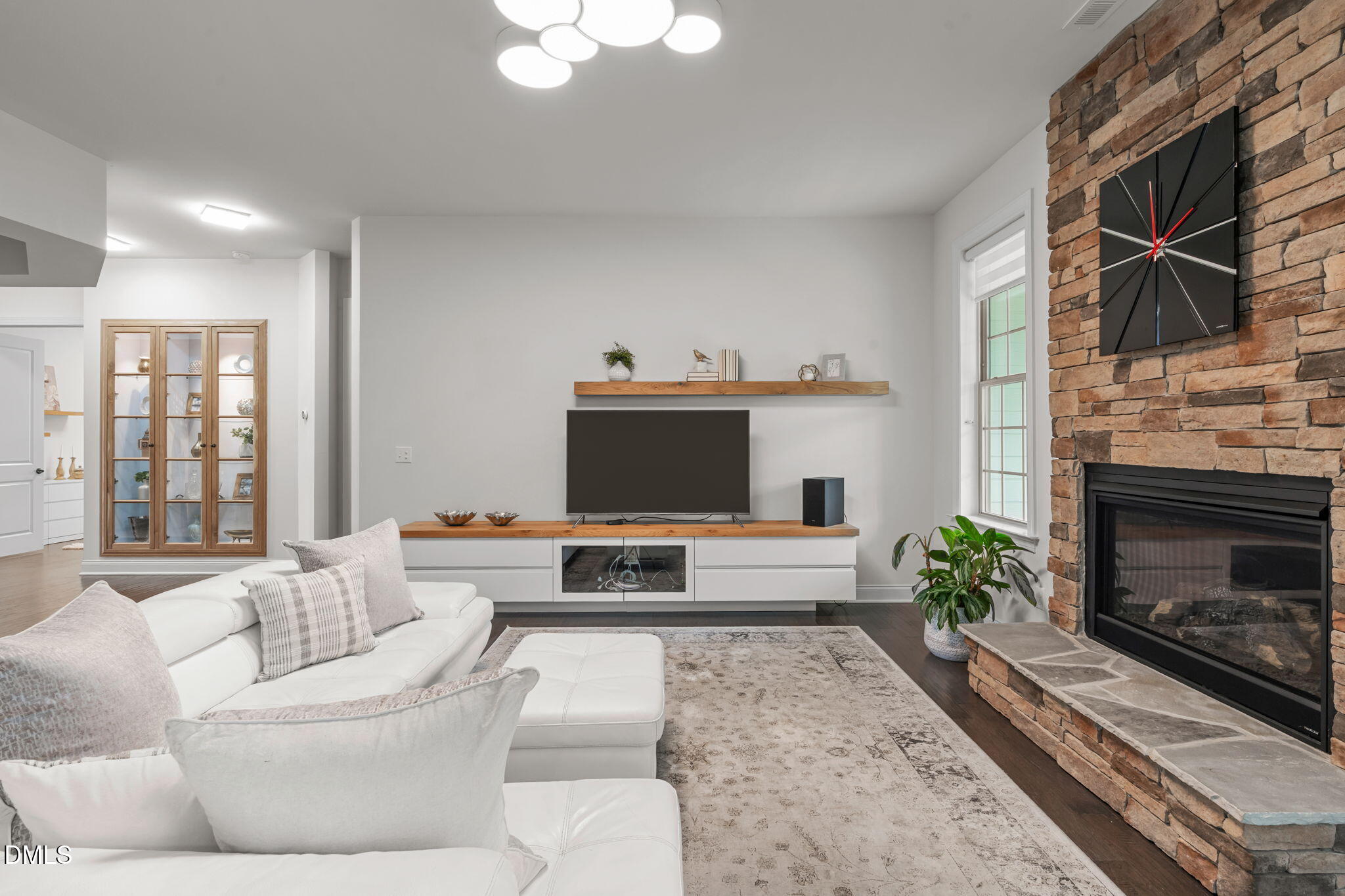 2613 Beckwith Road Apex, NC 27523 - Photo 10 of 73 a living room with furniture a fireplace and a flat screen tv