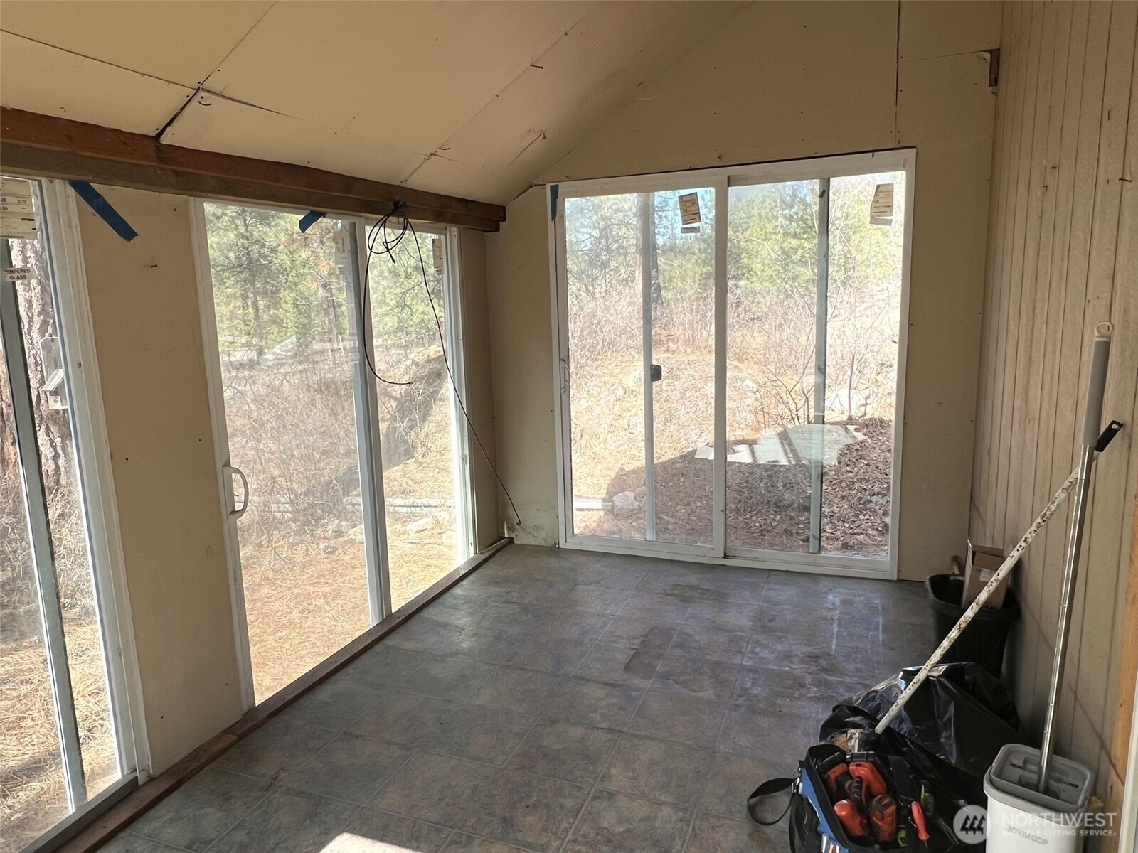 103 Stonehaven Road Tonasket, WA 98855 - Photo 4 of 38 a view of a room with gym equipment and windows