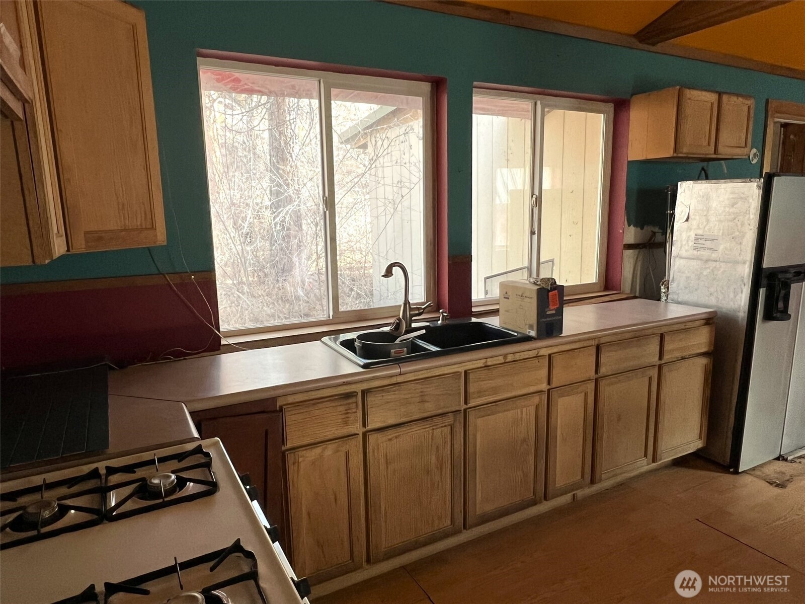103 Stonehaven Road Tonasket, WA 98855 - Photo 5 of 38 a kitchen with sink a window and a refrigerator