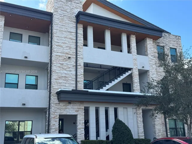 a front view of a house with large windows