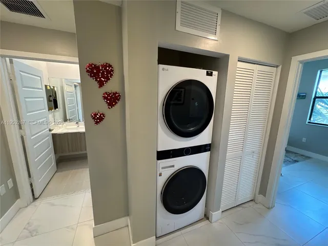 a view of a hallway with washer and dryer