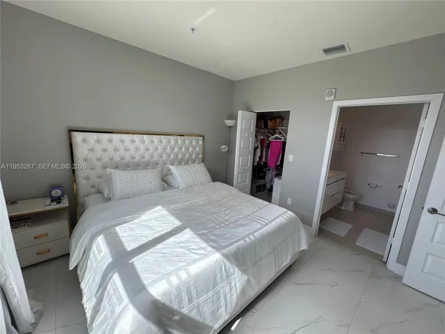 a bedroom with a bed and walk in closet