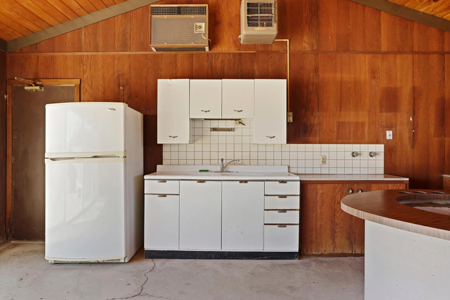 2465 Vernalis Road Tracy, CA 95304 - Photo 41 of 55 a kitchen with a refrigerator sink stove and cabinets