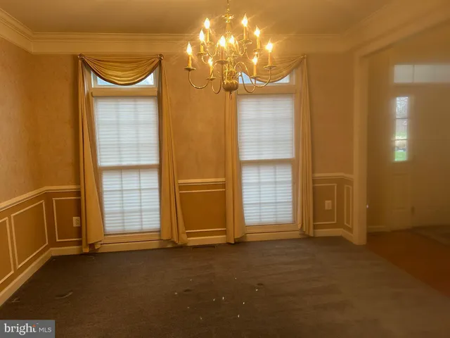 an empty room with a empty space and windows