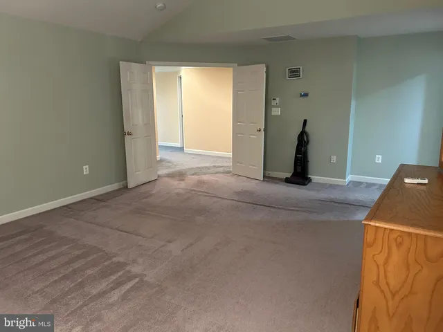 a bathroom with a shower and closet