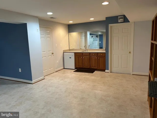 a spacious bathroom with a mirror and a sink