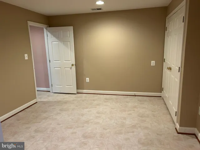 a view of an empty room with shelves