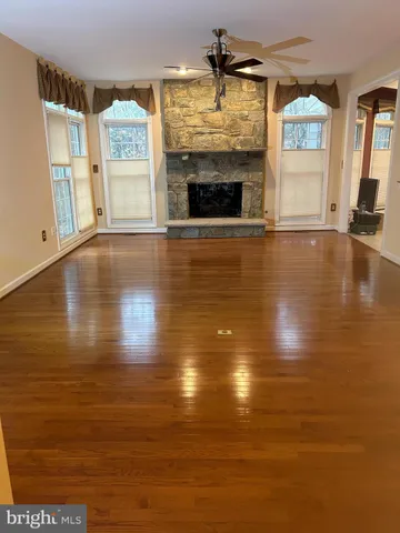 a view of an empty room with window and fireplace