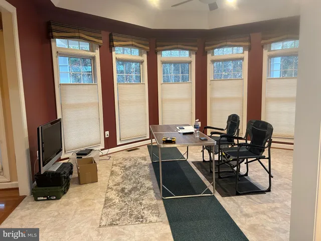 a view of a workspace with furniture and a window