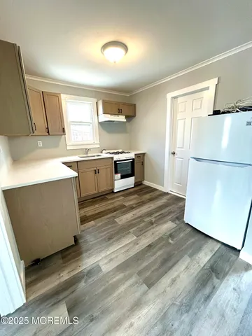 a kitchen with a refrigerator and a stove top oven
