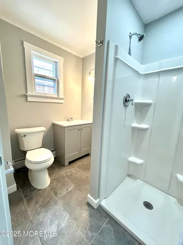 a bathroom with a toilet sink and shower