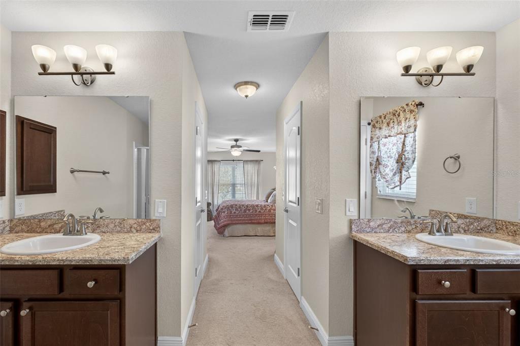 2429 Twin Lake View Road Winter Haven, FL 33881 - Photo 30 of 37 a en suite bathroom with a granite countertop sink a mirror and a shower