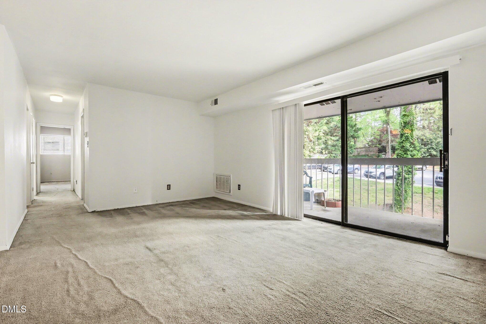 a view of an empty room with a sliding door