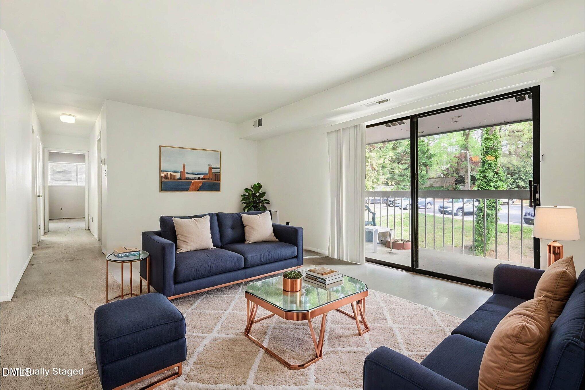 1014 Sandlin Place, Unit G Raleigh, NC 27606 - Photo 4 of 19 a living room with furniture and a large window