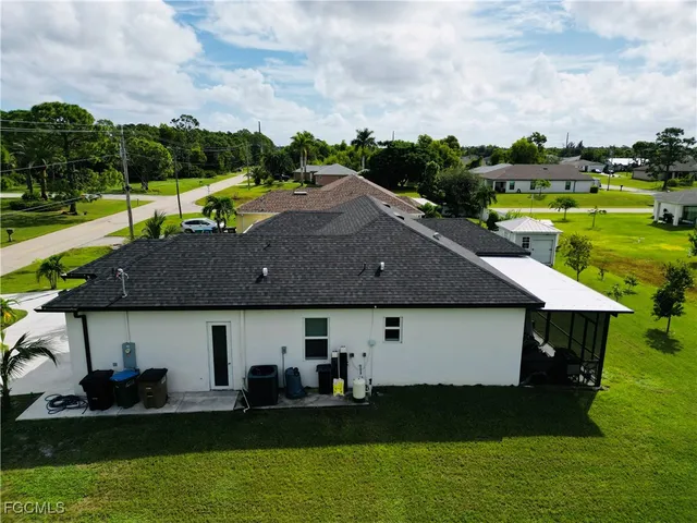 a aerial view of a house with a yard table and chairs