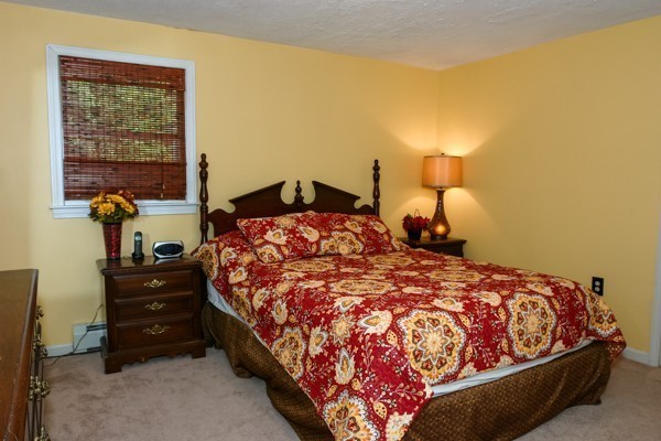 101 Sylvan Road Lancaster, MA 01523 - Photo 8 of 21 a bed sitting in a bedroom next to a window