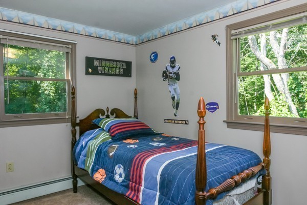101 Sylvan Road Lancaster, MA 01523 - Photo 10 of 21 a bed sitting in a bedroom next to a window