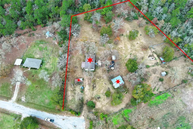 an aerial view of residential houses with outdoor space and street view