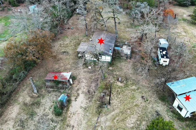 a backyard of a house with trees and entertaining space