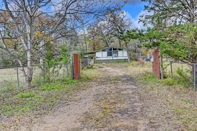 a view of a house with a yard and hanging chair