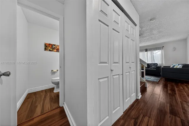 a view of a hallway view with wooden floor and staircase