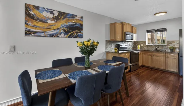 a dining room with furniture and wooden floor