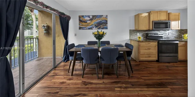 a view of a dining room with furniture a chandelier and wooden floor