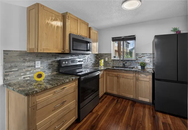 a kitchen with a sink a stove and refrigerator