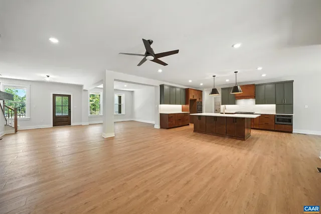 a kitchen with kitchen island a stove and a wooden floors