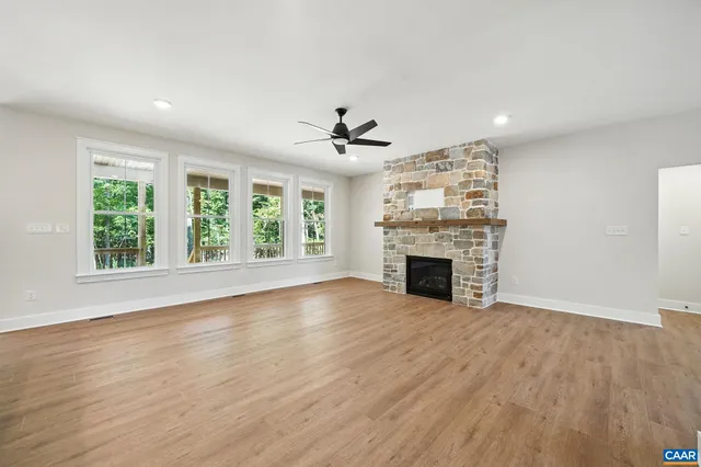 a living room with furniture kitchen view and a chandelier