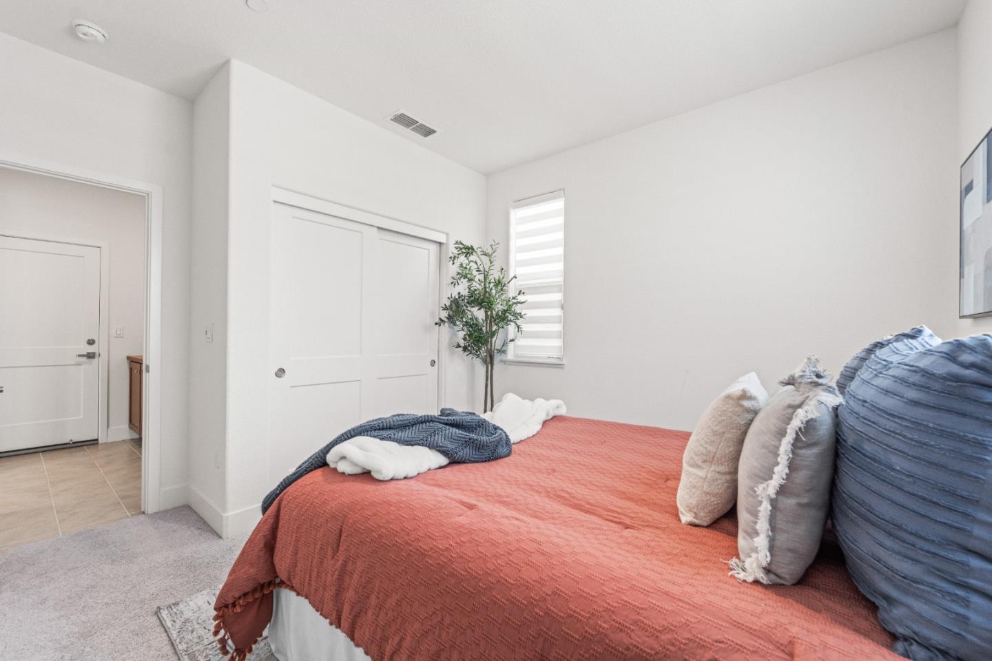 384 Ramos Ranch Road Oakley, CA 94561 - Photo 10 of 39 a bedroom with a bed and a potted plant