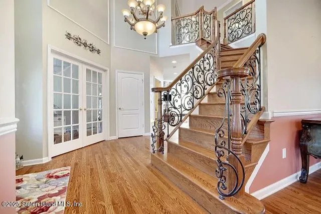 a view of entryway and hall with wooden floor