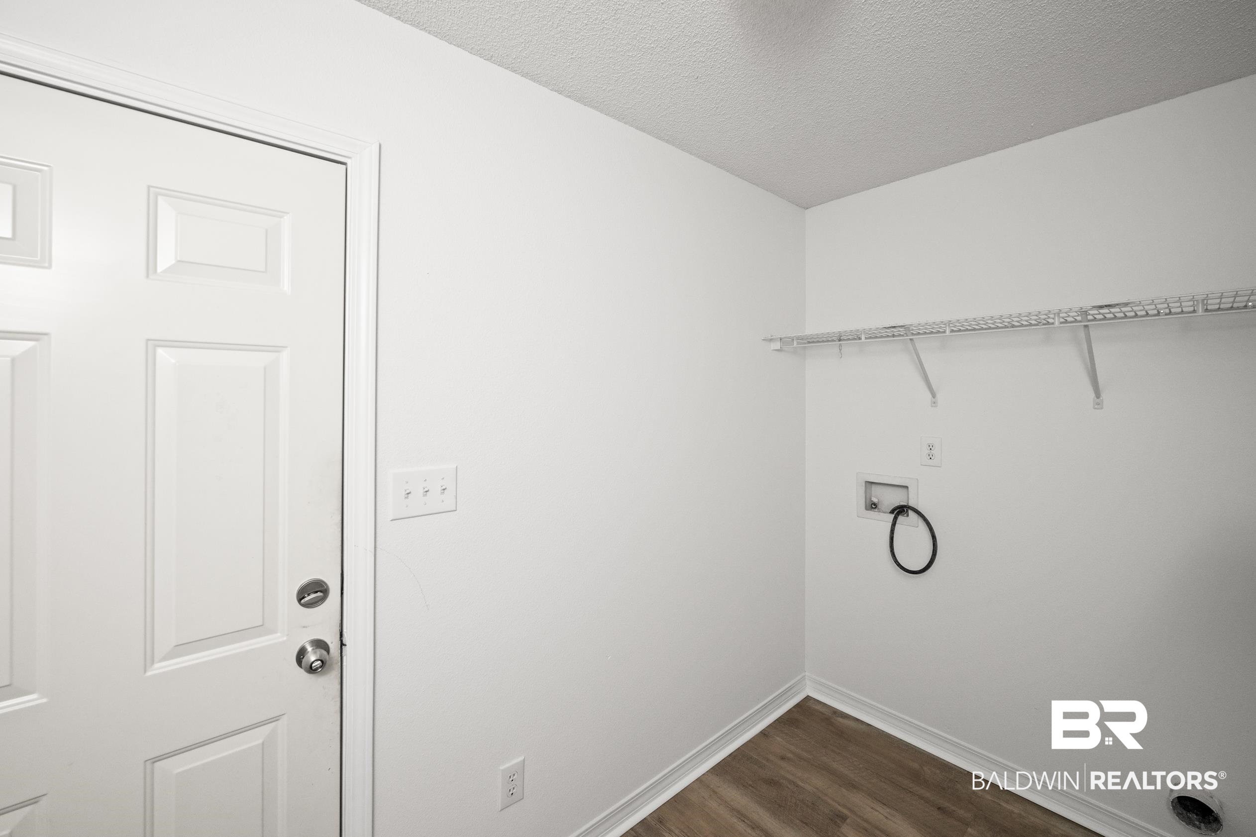 306 Monteith Oaks Drive Foley, AL 36535 - Photo 25 of 38 Laundry area featuring dark wood-style flooring, a textured ceiling, and washer hookup