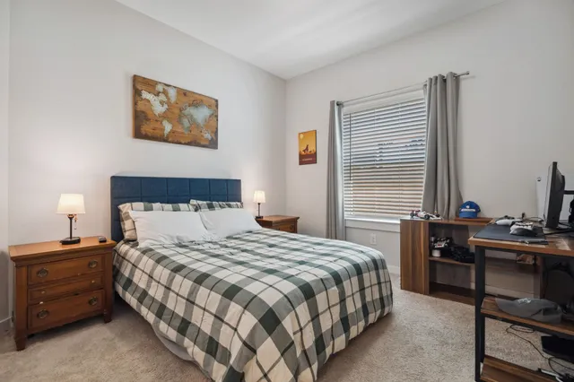 a bedroom with a bed and a window