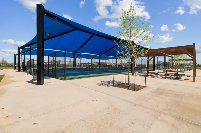 a view of a swimming pool with a yard and wooden fence