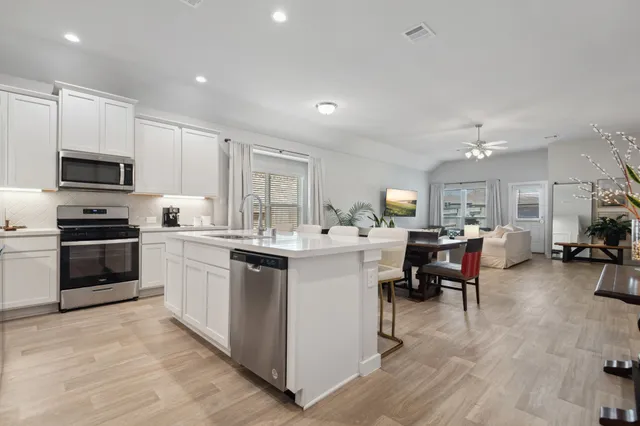 a kitchen with cabinets a sink and appliances