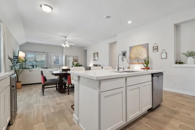 a kitchen with sink and white cabinets