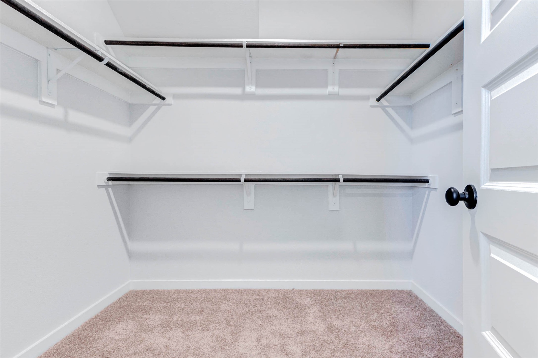 6406 Pomona Court Rosharon, TX 77583 - Photo 22 of 33 Step into the expansive walk-in closet off the primary suite offering double-tier hanging rods and abundant space for organizing wardrobes of all seasons. This closet adds true functionality to the owner's retreat.